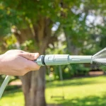 Holman ColourDip™ Green 12mm x 15m garden hose with adjustable nozzle, perfect for versatile garden watering