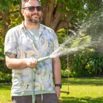 Holman ColourDip™ Green 12mm x 15m garden hose with adjustable nozzle, perfect for versatile garden watering